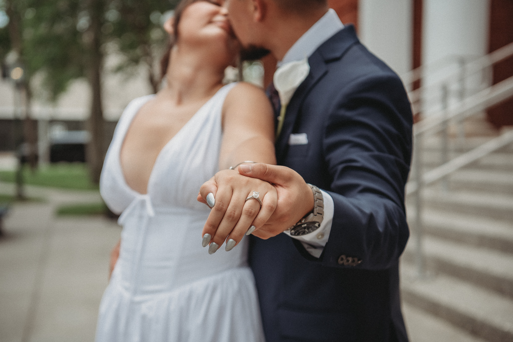 Bride and groom embracing on the steps of the Brooksville Courthouse