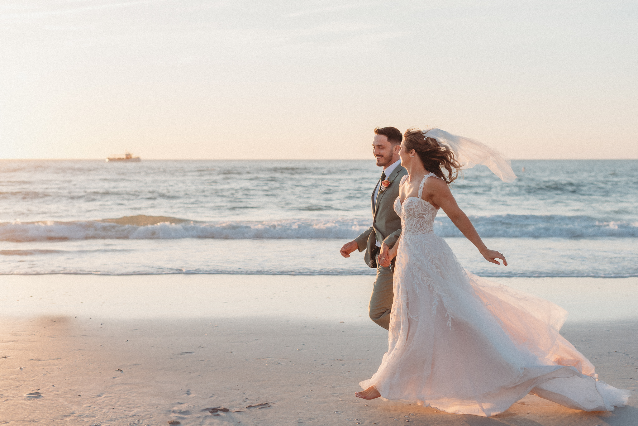 Romantic cinematic sunset wedding photography Clearwater bride and groom running on beach