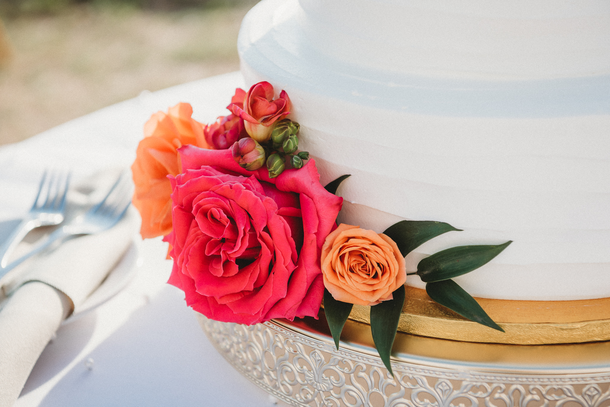 Elegant waterfront wedding cake with vibrant floral details on Florida’s Gulf Coast