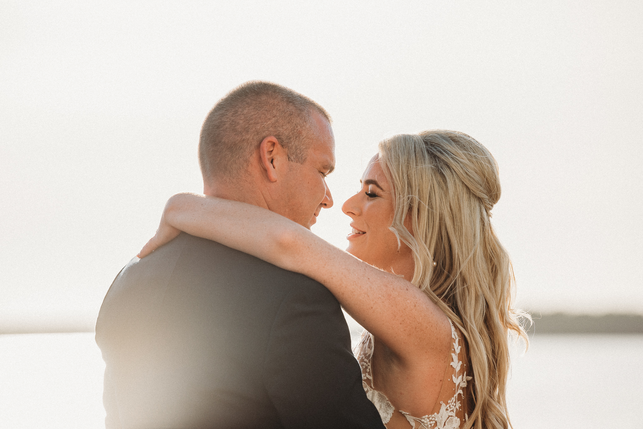 Romantic bride and groom portraits along the Tampa Bay shoreline at sunset